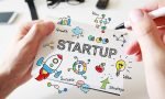 Mans hand drawing Startup concept on notebook