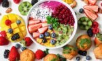 assorted sliced fruits in white ceramic bowl
