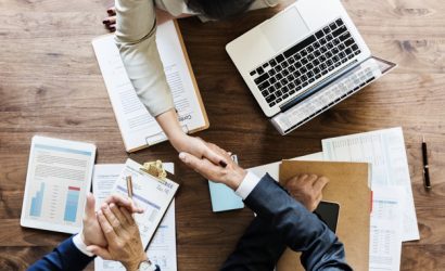 Business people shaking hands together
