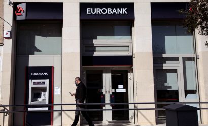 A man walks outside a Eurobank branch in Athens