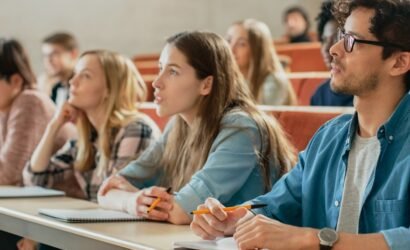 In the Classroom Multi Ethnic Students Listening to a Lecturer and Writing in Notebooks. Smart Young People Study at the College.